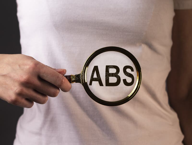 Palavra abs através de amplificador na mão feminina fotografia de stock