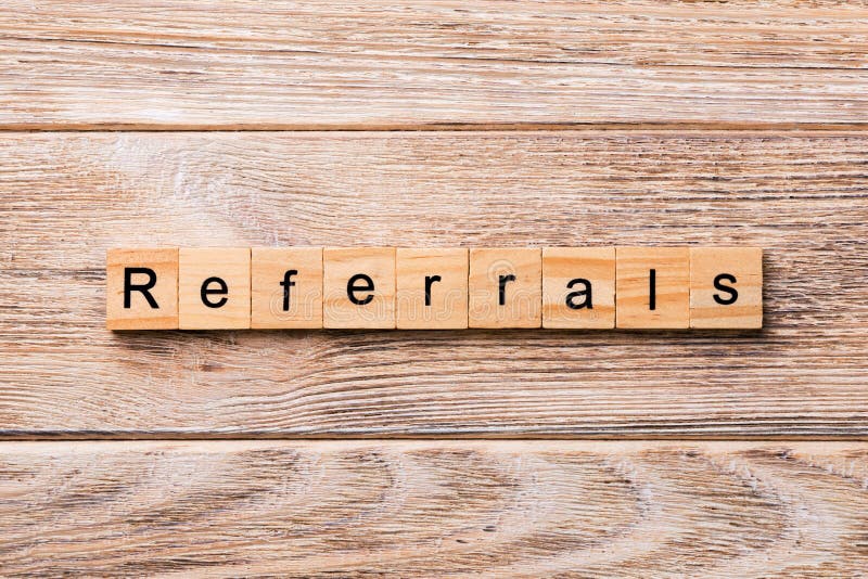 REFERRALS word written on wood block. REFERRALS text on wooden table for your desing, concept. REFERRALS word written on wood block. REFERRALS text on wooden table for your desing, concept.