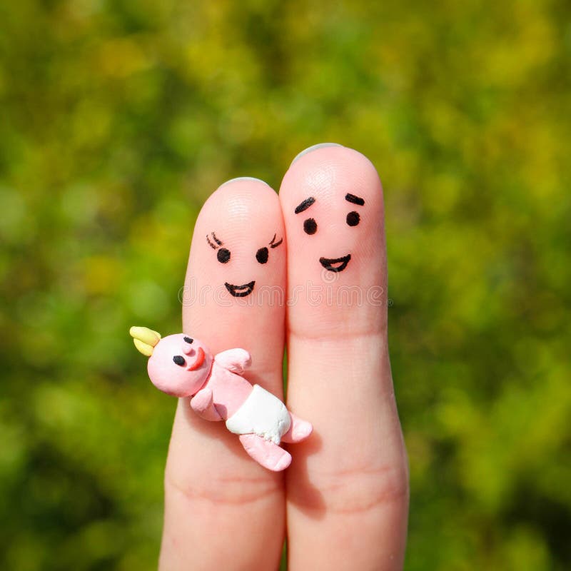 Finger art of a Happy couple. Happy family holding a small child. Finger art of a Happy couple. Happy family holding a small child.