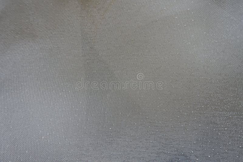 Pale cream colored shiny sheer fabric