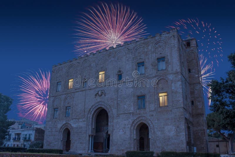 Celebratory fireworks for new year over La Zisa in Palermo Sicily, shot of one of the best preserved Norman castles in Italy during last night of year. Christmas blue atmosphere. Celebratory fireworks for new year over La Zisa in Palermo Sicily, shot of one of the best preserved Norman castles in Italy during last night of year. Christmas blue atmosphere