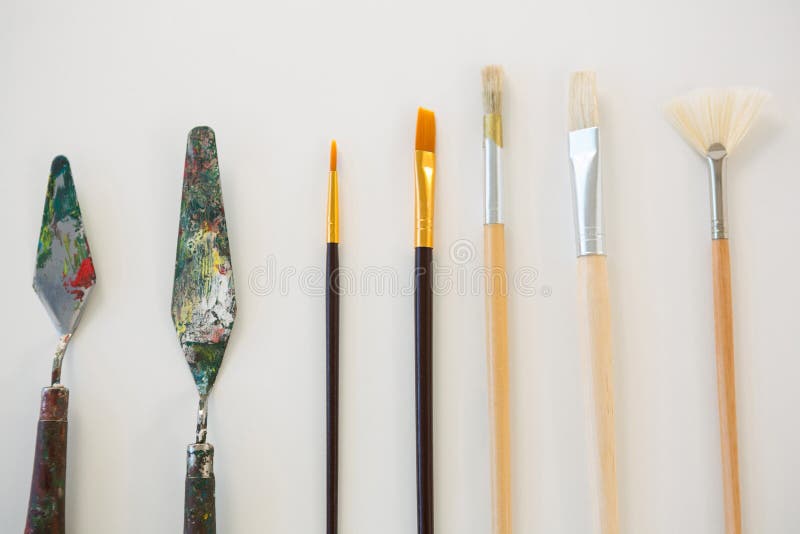 Palette Knives and Paint Brushes Arranged in a Row Stock Photo Image