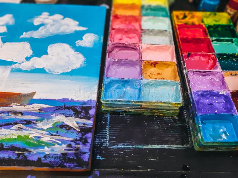 The palette water paints on the table, many color in the palette water paints royalty free illustration