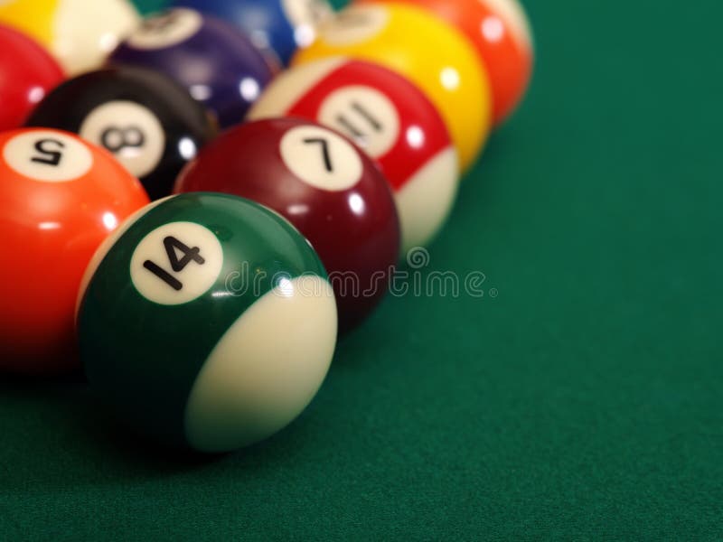 Macro photo of a pool table and billiard balls with space for copy. Shallow depth of field with focus on the fourteen ball. Macro photo of a pool table and billiard balls with space for copy. Shallow depth of field with focus on the fourteen ball.