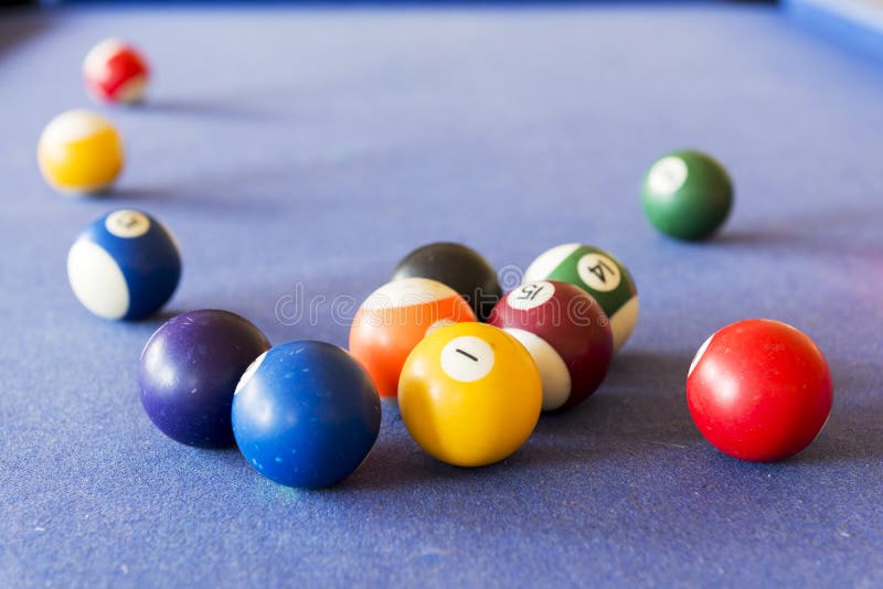 Playing pool on a pool table with billiard balls. Playing pool on a pool table with billiard balls