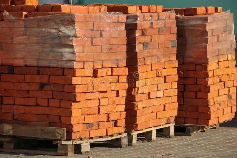 Pallets with red bricks stock image. Image of materials 121153483