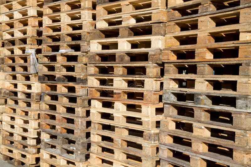 Pallets stacked in piles stock photo. Image of business - 21991814