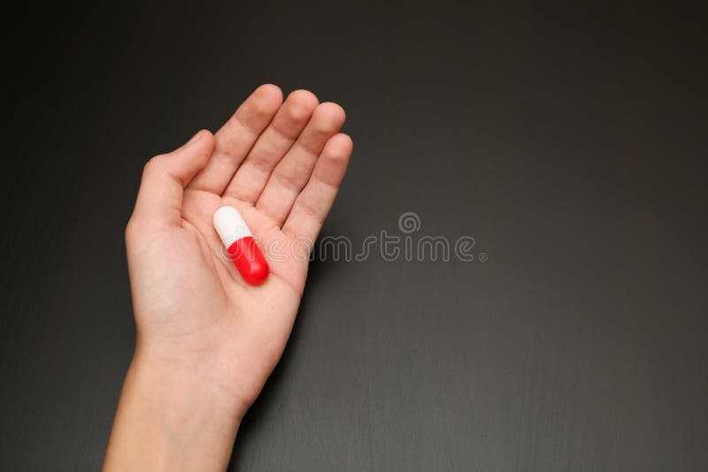 the palm of the hand gives help pill capsule for pain stress pain reliever red and white two halves antibiotic wishes health wants