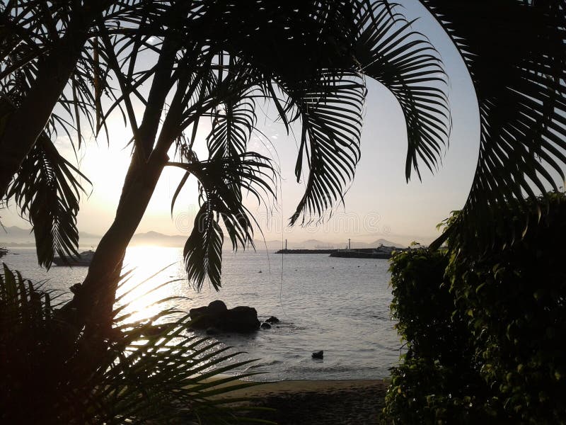 A tropical sunrise over Manzanillo Bay at Las Hadas Resort in Manzanillo, Colima, Mexico. A tropical sunrise over Manzanillo Bay at Las Hadas Resort in Manzanillo, Colima, Mexico.