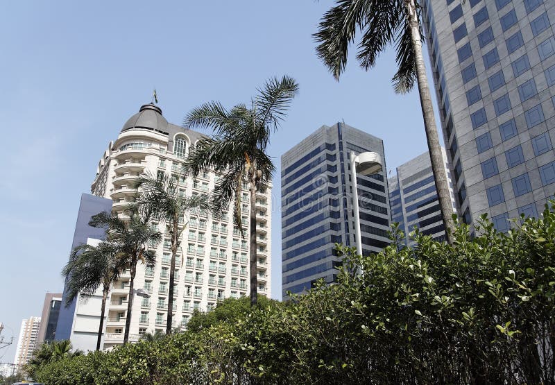 A classic building on a corner in Sao Paulo, some palm trees on line and three coporate business towers. Brazil. A classic building on a corner in Sao Paulo, some palm trees on line and three coporate business towers. Brazil.