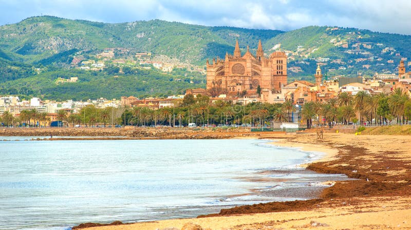 Sand beach in Palma de Mallorca with gothic cathedral in background, Spain. Sand beach in Palma de Mallorca with gothic cathedral in background, Spain