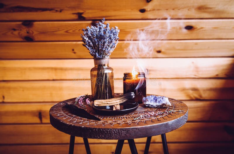 Palo Santo wood known as oily aromatic holy wood sticks smouldering on plate in home living room cleansing negative energy concept