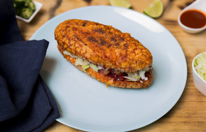 Pambazo, piatto regionale messicano preparato con patate, chorizo, panna, lattuga e formaggio a strisce fotografie stock