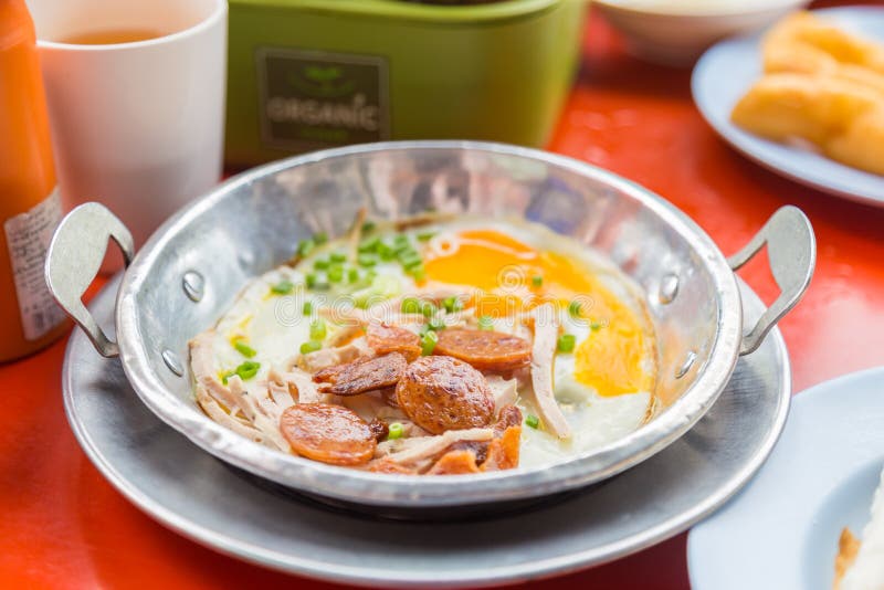A Pan Fried Egg with Toppings on the Red Table. Stock Image Image of