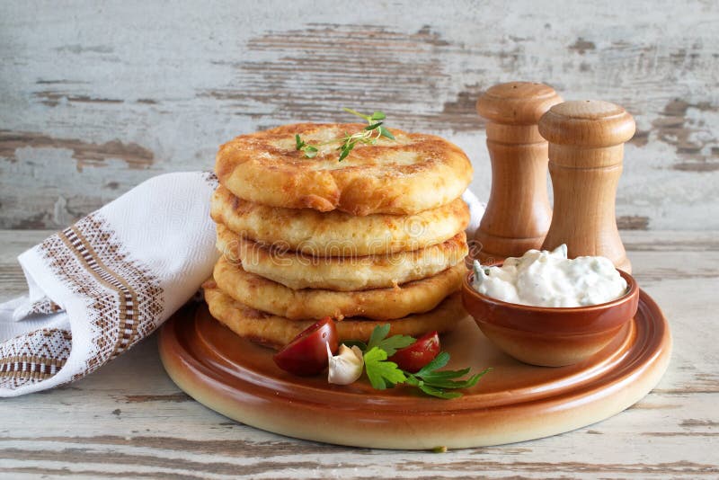 Pan fried potato tortillas served with yogurt sauce and fresh vegetables stock photos Pan fried potato tortillas served with yogurt sauce and fresh vegetables stock photos