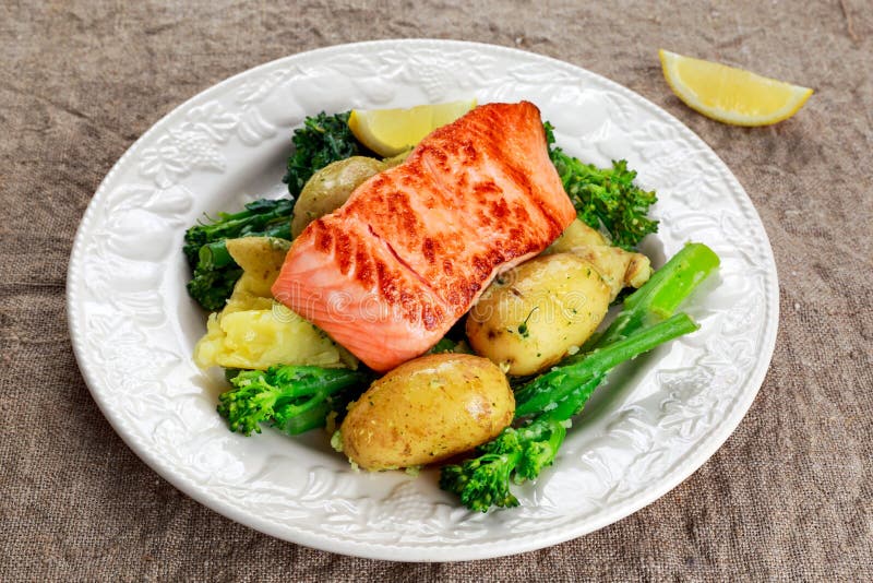 Pan Fried Salmon Served with Potatoes and Tenderstem Broccoli. Stock