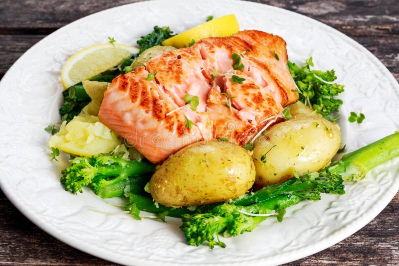 Pan Fried Salmon Served with Potatoes and Tenderstem Broccoli. Stock ...