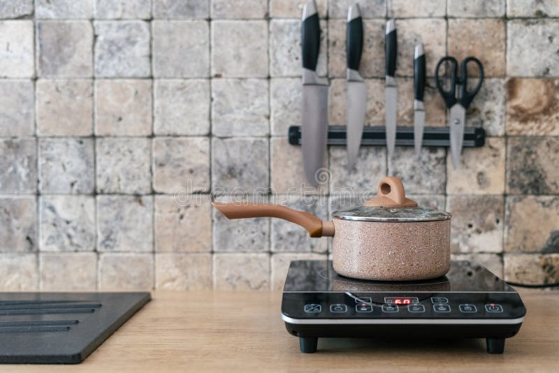 Pan at Small Electric Stove with Control Panel in Kitchen Stock Image