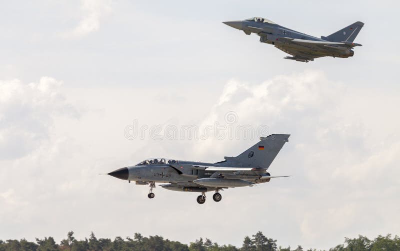 Panavia Tornado and a eurofighter typhoon lands on airport