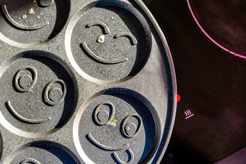 Pancake Frying Pan with Smile Face Pancake Cooking on Cooker in Kitchen
