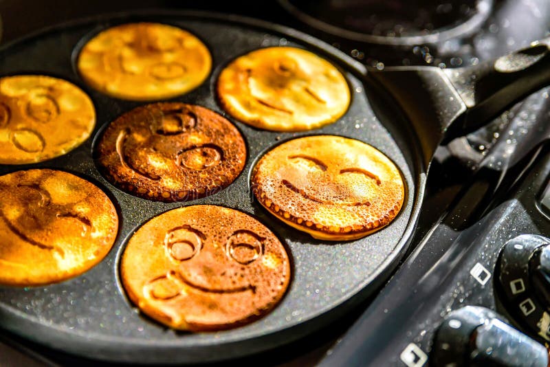Pancake Frying Pan with Smile Face Pancake Cooking on Cooker in Kitchen