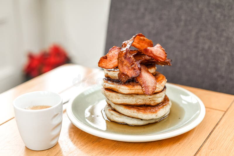 Pancake Stack with Golden Syrup and a Large Portion of Bacon As a Breakfast or Brunch Meal Stock