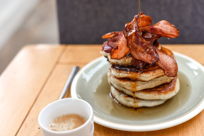 Pancake Stack with Golden Syrup and a Large Portion of Bacon As a