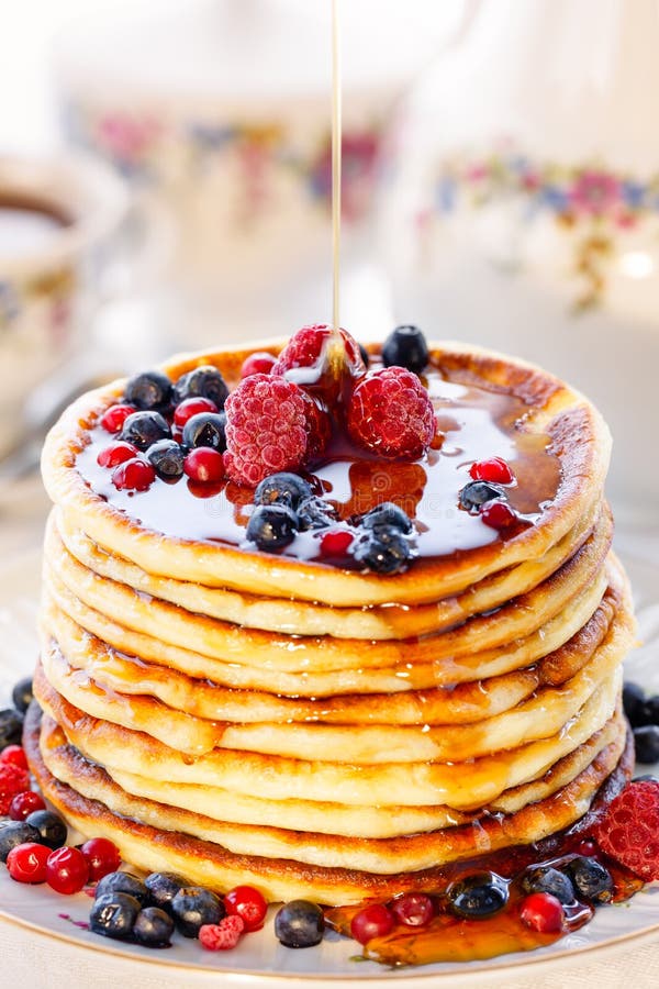 Pancakes with berries and honey. Meal, background.