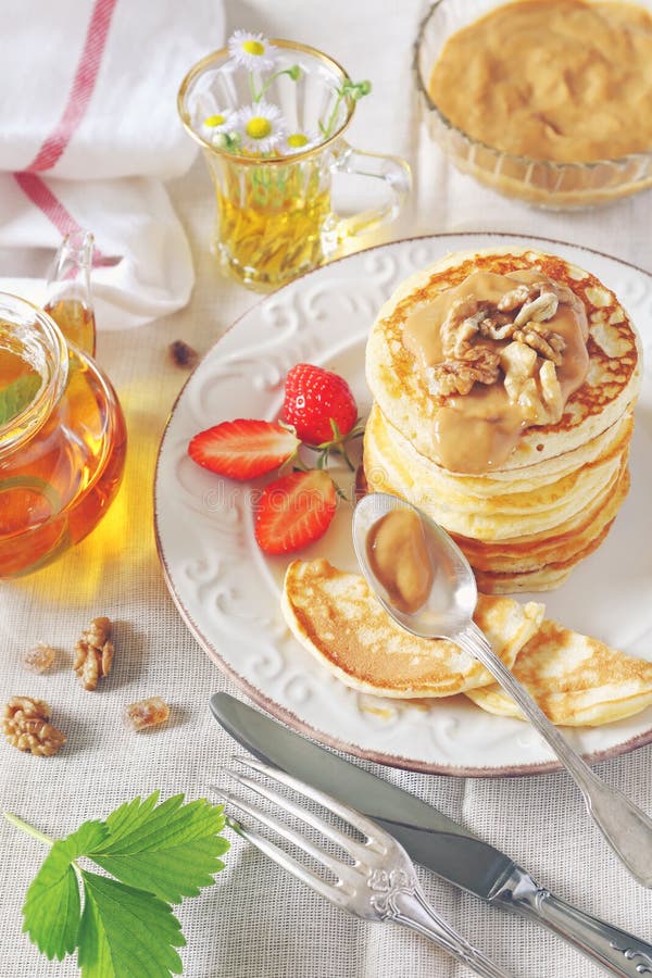 Pancakes with Caramel Sauce, Strawberries and Herbal Tea Stock Photo