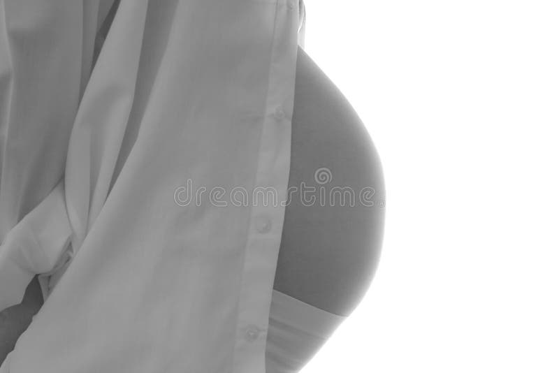 View from the side of a pregnant woman with white shirt. Isolated; black & white. View from the side of a pregnant woman with white shirt. Isolated; black & white