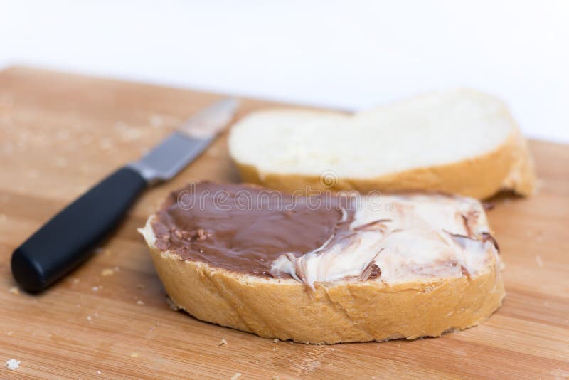 Pane con cioccolato e la crema delle nocciole sul pane immagini stock libere da diritti