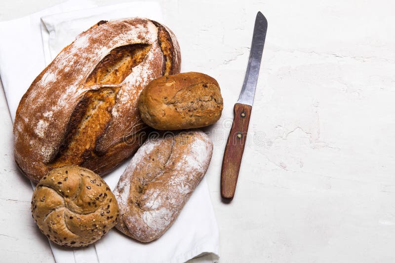 Pane scuro e panini saporiti su fondo bianco, spazio della copia immagini stock libere da diritti Pane scuro e panini saporiti su fondo bianco, spazio della copia immagini stock libere da diritti