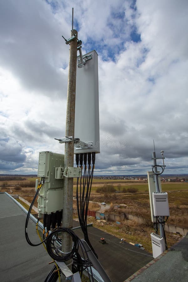 Panel antenna of GSM DCS UMTS LTE bands, GPS antenna and remote radio unit are as part of communication equipment of basic station are installed on the tubular mast on the roof. Panel antenna of GSM DCS UMTS LTE bands, GPS antenna and remote radio unit are as part of communication equipment of basic station are installed on the tubular mast on the roof.