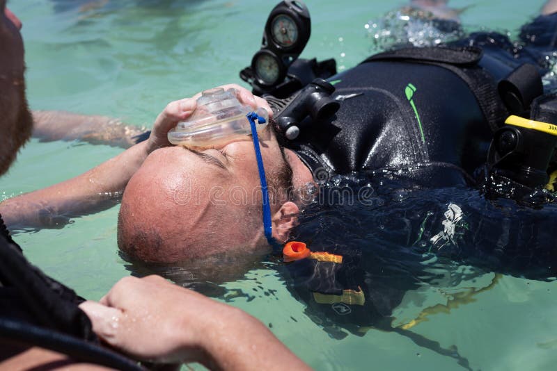 Panglao, Philippines - April 29, 2021: Scuba diver, instructor in confined water teaching, studying, evaluating skills, rescue ski. Scuba diver, instructor in