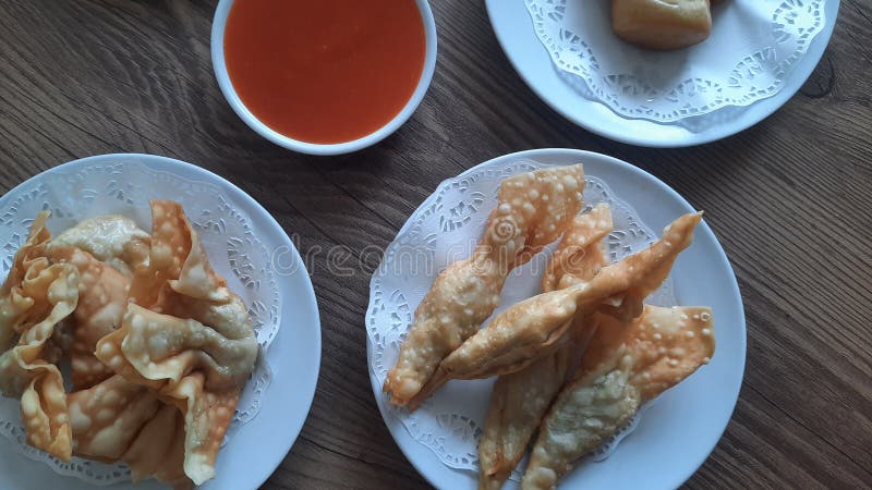 Pangsit, Pangsit Goreng, delicious Pangsit Ayam Goreng (Chicken Fried Dumpling), Indonesia Traditional Food made from flour and chicken, served on white sauce