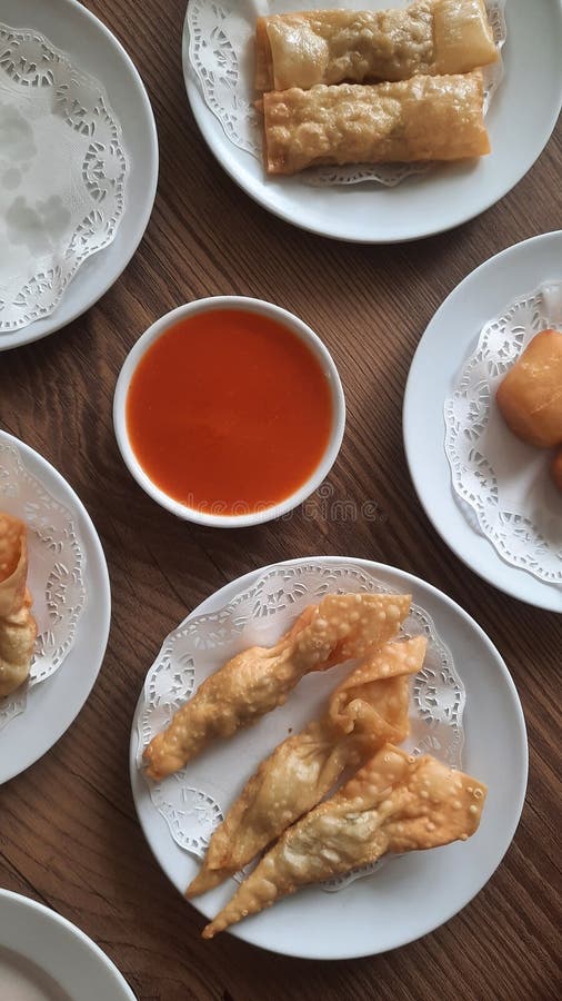 Pangsit, Pangsit Goreng, delicious Pangsit Ayam Goreng (Chicken Fried Dumpling), Indonesia Traditional Food made from flour and chicken, served on white sauce