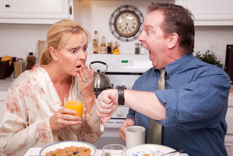 Panicked Couple in Kitchen Late for Work stock photos Panicked Couple in Kitchen Late for Work stock photos