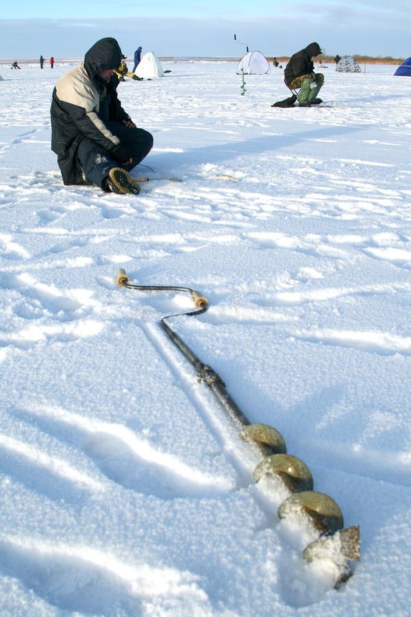 Fishing drill on an ice of the frozen lake. Fishing drill on an ice of the frozen lake