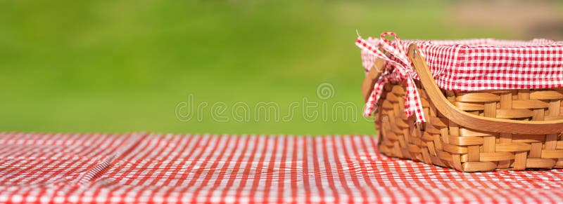 picnic basket on a table with a red tablecloth. Summer mood. relaxation. holidays/. picnic basket on a table with a red tablecloth. Summer mood. relaxation. holidays/