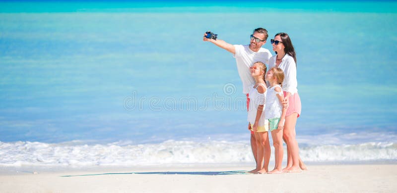 Panorama av den lyckliga härliga familjen på stranden royaltyfri fotografi Panorama av den lyckliga härliga familjen på stranden royaltyfri fotografi