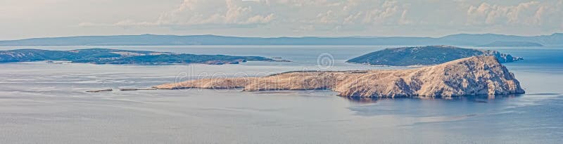 Expansive view of the uninhabited and rocky Goli Otok island as former prison in Yugoslavia against the backdrop of the calm Adriatic Sea. Expansive view of the uninhabited and rocky Goli Otok island as former prison in Yugoslavia against the backdrop of the calm Adriatic Sea.