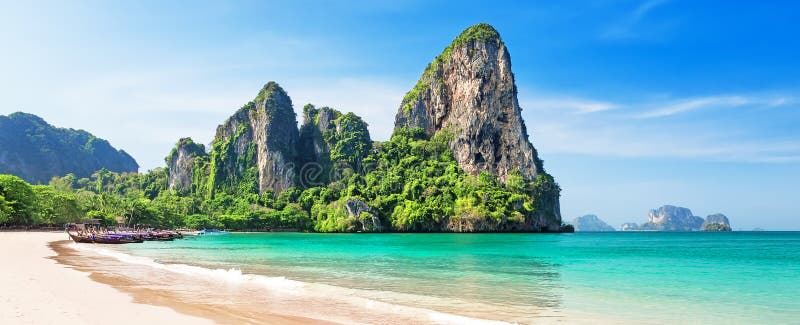 Panorama of beautiful sand Railay beach and thai traditional wooden longtail boat in Krabi province, Thailand