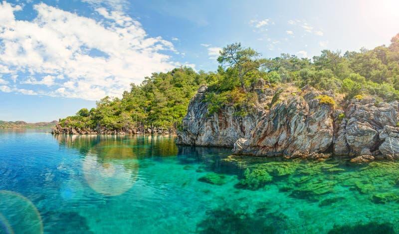 Panorama of blue lagoon brightly lit with sinlight