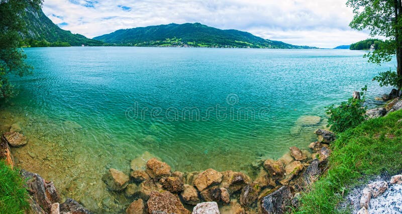 Panorama a blue transparent alpine lake. stock photo