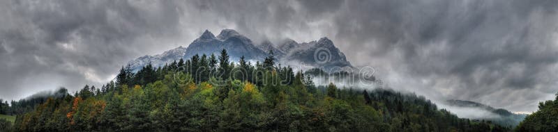 Panorama of Cloudy Mountains and a Forest