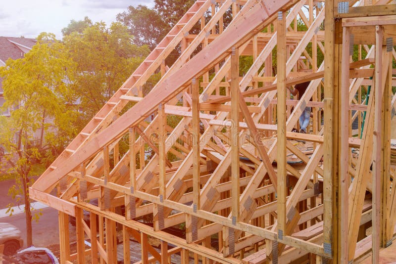 Panorama of condominium building with under construction wooden house with timber framing, truss, joist, beam close-up. Panorama of modern condominium building royalty free stock photo Panorama of condominium building with under construction wooden house with timber framing, truss, joist, beam close-up. Panorama of modern condominium building royalty free stock photo