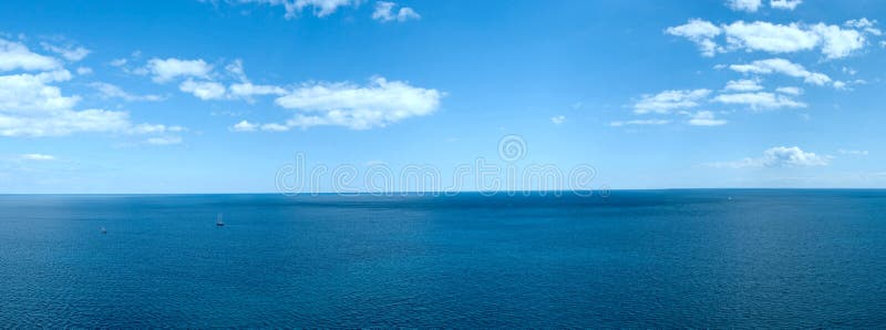 Panorama of a sea landscape with white clouds and the quiet blue water. Panorama of a sea landscape with white clouds and the quiet blue water