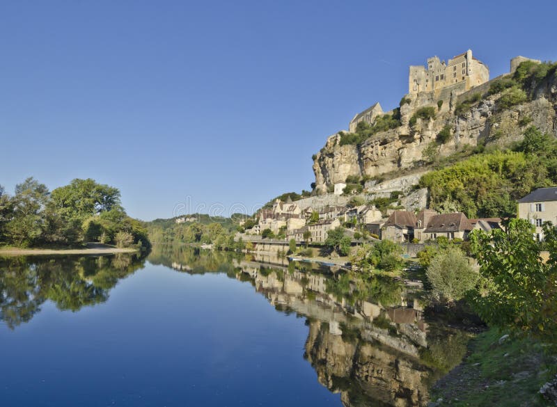 A tranquil scene at the Dordogne River at Beynac in the Aquitaine area of France on a cold late September morning. Medieval Beynac Village is said to be one of the most scenic villages in France. In the Middle Ages the area was the border between French and English territories. A tranquil scene at the Dordogne River at Beynac in the Aquitaine area of France on a cold late September morning. Medieval Beynac Village is said to be one of the most scenic villages in France. In the Middle Ages the area was the border between French and English territories.