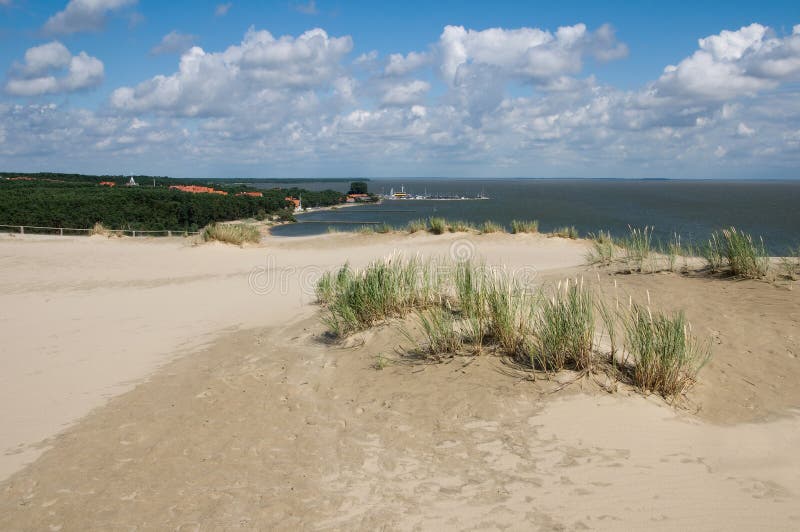 Looking down at Nida town from a top of a Parnidis dune at Curonian spit in Lithuania. UNESCO word heritage site. Looking down at Nida town from a top of a Parnidis dune at Curonian spit in Lithuania. UNESCO word heritage site