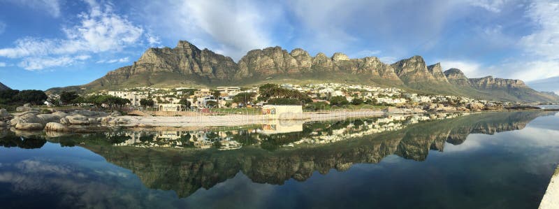 Reflection pool at the Camps Bay Beach on a calm day with little wind, great views of the Twelve Apostles of the Table Mountain National Park. Reflection pool at the Camps Bay Beach on a calm day with little wind, great views of the Twelve Apostles of the Table Mountain National Park